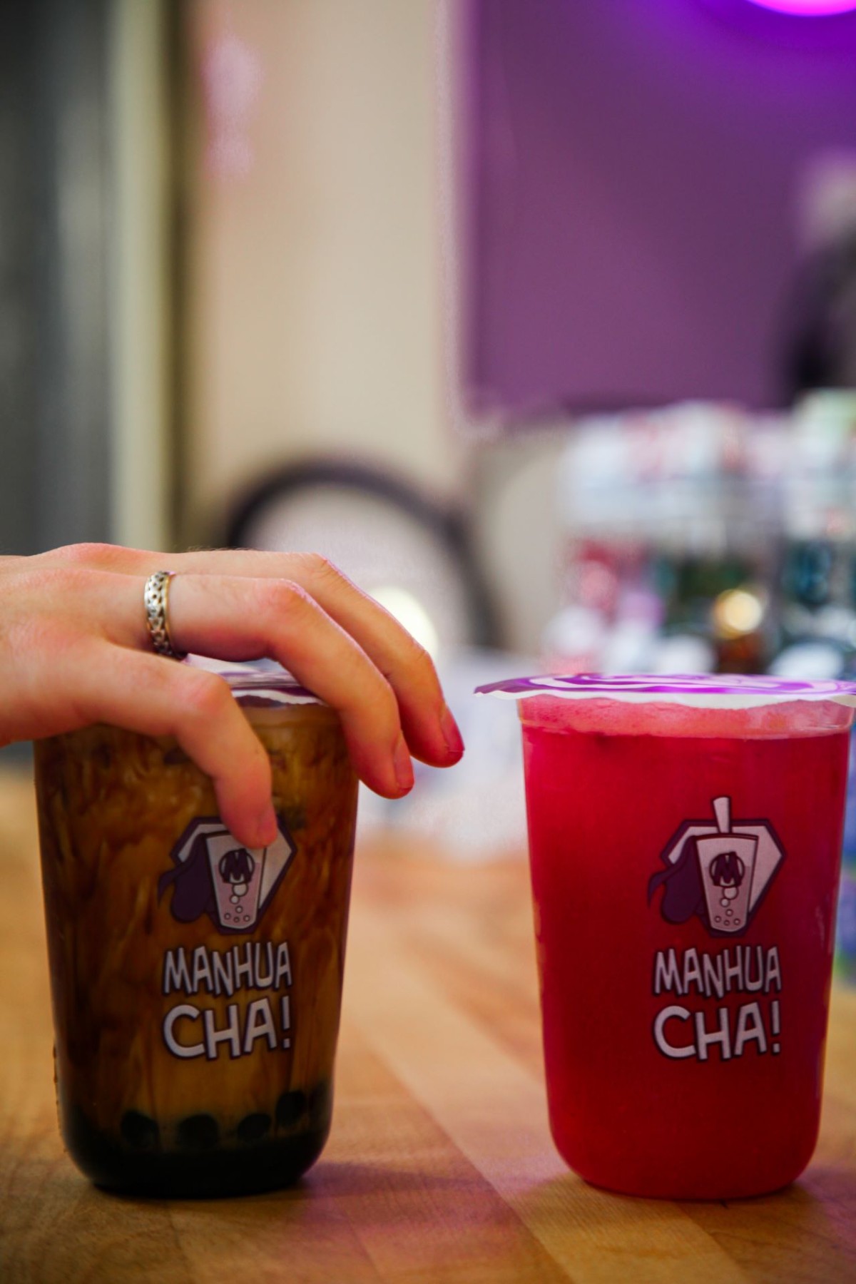 Two brightly coloured flavoured bubbl teas in plastic containers